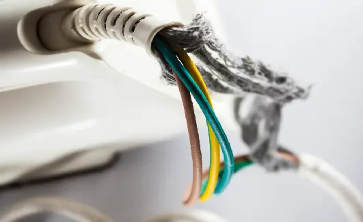 Exposed wires in an corroded appliance power cord presenting a fire risk